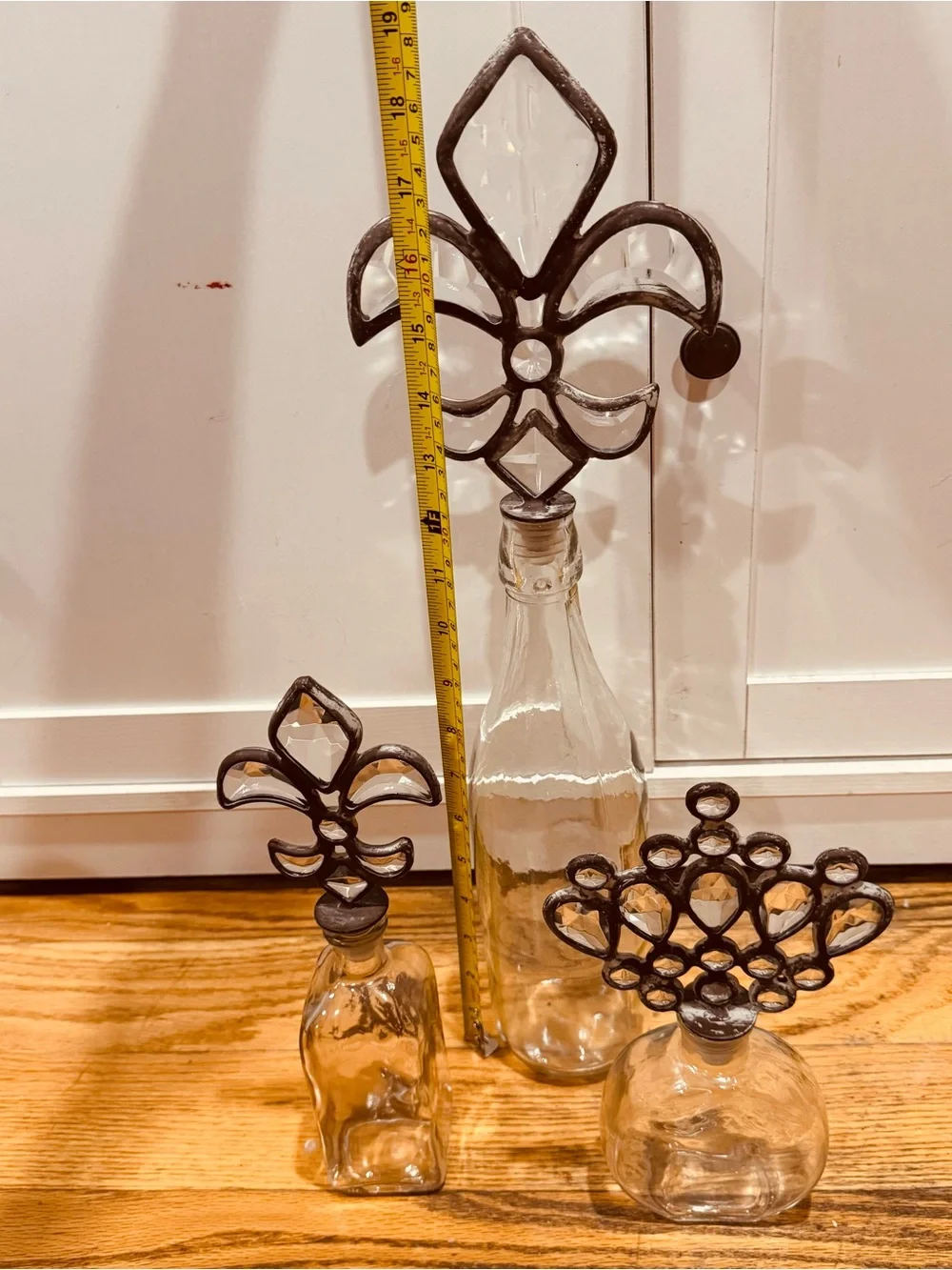 Vintage Decorative Glass Bottle Trio with Fleur & Crown Stoppers - Clear